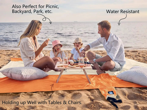Family on Sandproof And Waterproof Beach Blanket 7x7 Ft Extra Large Mat With Stakes enjoying picnic by the sea on sand