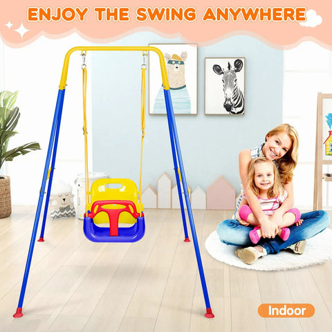 Indoor setting with a blue and yellow child swing on a metal stand, mother and daughter sitting nearby, illustrations on wall.