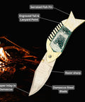 Damascus Fish Style Folding Knife with Ladder Pattern Blade, Brass Engraved Green Resin Handle against campfire background.