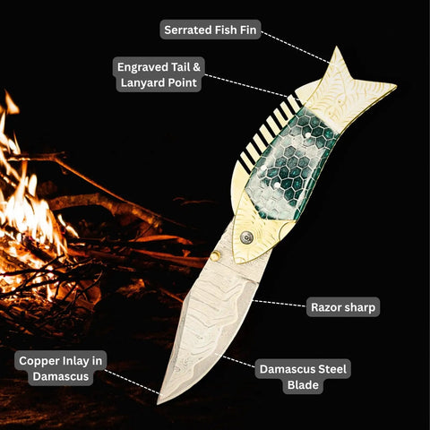 Damascus Fish Style Folding Knife with Ladder Pattern Blade, Brass Engraved Green Resin Handle against campfire background.