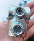 Three Quarter Inch Galvanized Pipe Fittings Single Socket Tee 90-Degree Connector held in hand close-up view