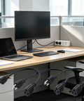 Three Six Pack 16 Awg 13 Amp Heavy Duty Indoor Extension Cords One Foot with grounded plugs on an office desk with a monitor and laptop.