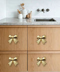 Six Piece Zinc Alloy Bow Drawer Knobs With Vintage Plating And Smooth Curved Handles For Dressers And Vanity Furniture Upgrades That Bring Main Character Energy To Your Space on wooden cabinets under countertop.