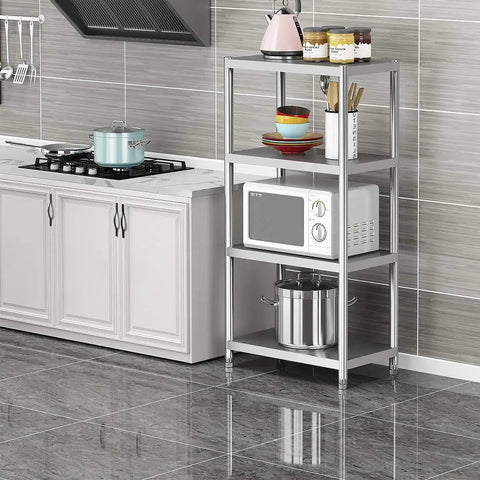 Stainless steel kitchen shelving unit with microwave and cookware, next to modern cabinets in tiled kitchen.