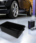 Sturdy Plastic Oil Change Pan With Wide Mouth For Effortless Draining And Recycling Of Engine Oil In Cars And Commercial Trucks For Easy Maintenance beside a car.