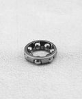 Close-up of single durable pro-grade 4 pack bike ball bearing retainer cage with 7 balls, one quarter inch size for front wheel.