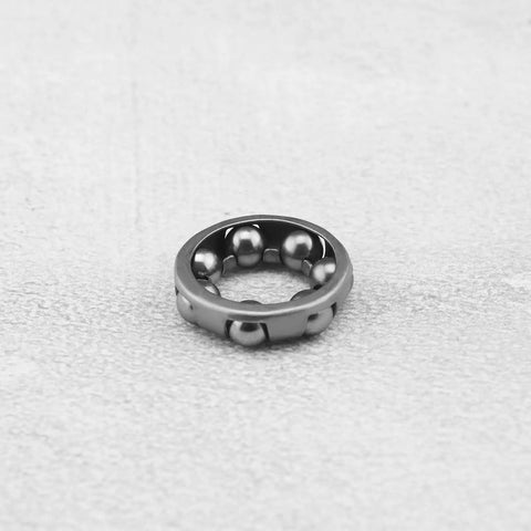Close-up of single durable pro-grade 4 pack bike ball bearing retainer cage with 7 balls, one quarter inch size for front wheel.