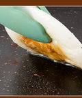 Egg being lifted with tongs on Thin 9.4 Inch Iron Grill Pan With Nonstick Coating For Stovetop Cooking, indoor use.