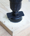 KENDO hole saw attached to drill cutting softwood; sawdust around.