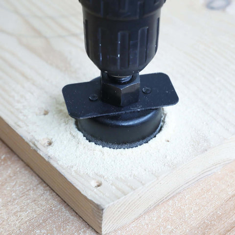 KENDO hole saw attached to drill cutting softwood; sawdust around.
