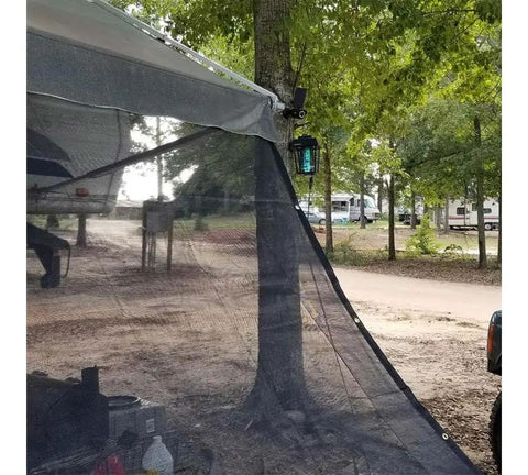 12x24 Ft Black 70 Percent Shade Mesh Tarp With Grommets Beefy Heavy Duty 6 Oz Poly Shade Net in outdoor setup under trees