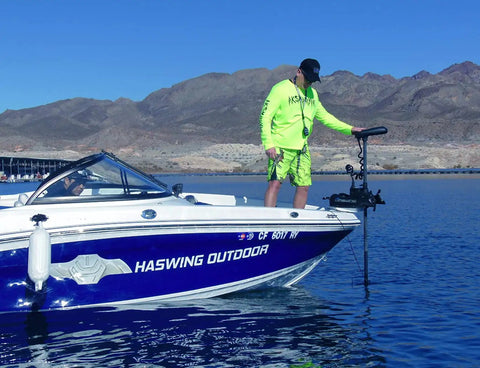 Man using Built Tough 12V 55 LB Electric Trolling Motor With 48 Inch Bow Mount Shaft on boat for fishing.