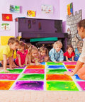 Children playing on Six Assorted Color 12 by 12 Inch Liquid Floor Tiles Set for Kids in a playroom, tiles changing color with movement.