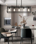 Farmhouse Black 5 Light Kitchen Island Pendant Light Set hanging over modern dining table in stylish kitchen.