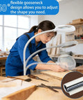 Woman using Eight Times Magnification Floor Magnifying Glass With Light And Stand in woodworking shop, focus on 360° gooseneck.