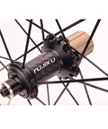 Close-up of a hub on the Ultra Light 700C Carbon Fiber Road Bike Wheelset with Ceramic Bearings front rear quick release V brake.