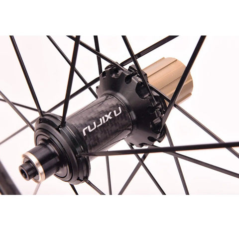 Close-up of a hub on the Ultra Light 700C Carbon Fiber Road Bike Wheelset with Ceramic Bearings front rear quick release V brake.