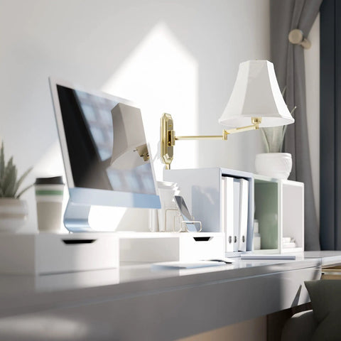 Polished Brass Wall Swing Arm Lamp With Off White Fabric Shade Delivers Classic Vibe And Traditional Style in a modern desk setting