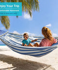 Built Tough Portable Camping Hammock With 550Lb Capacity in use on beach, blue white striped, 320G canvas, anti roll beams visible