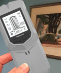 Stud Finder Depth Recognition LCD Display Audio Alarm Detector held in hand, showcasing detailed LCD screen and device features.