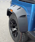 Close-up of the rear tire and fender of the Buttery Smooth 4 Seat Electric Golf Cart With 48V Torque Monster Motor And Premium Stitched Seats For Chill Neighborhood Cruises Or Weekend Farm Hauls In Clean Blue.
