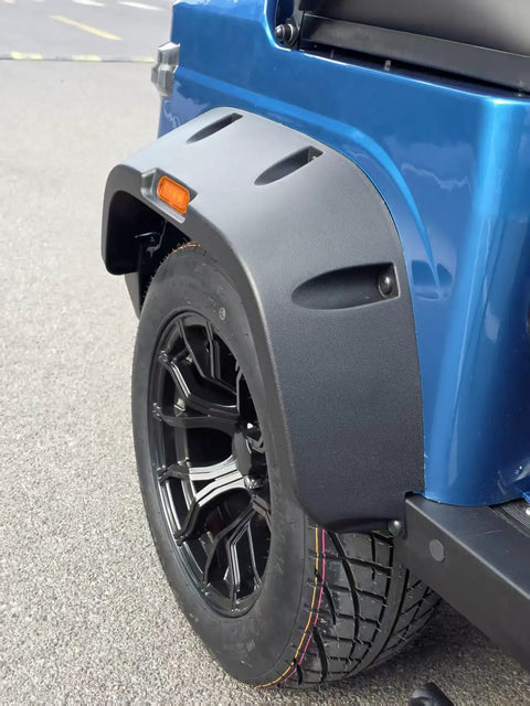 Close-up of the rear tire and fender of the Buttery Smooth 4 Seat Electric Golf Cart With 48V Torque Monster Motor And Premium Stitched Seats For Chill Neighborhood Cruises Or Weekend Farm Hauls In Clean Blue.