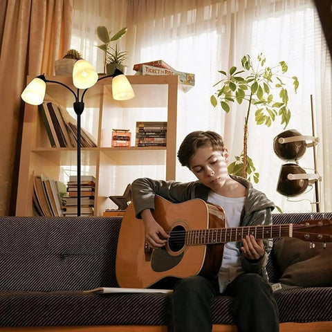 Three Light Black Reading Floor Lamp With Adjustable Heads, 66 Inch Tall Standing Tree Lamp in living room with boy playing guitar
