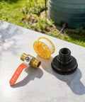 Rock Solid One Half Inch Brass Ball Valve With Bsp Male Threads For Water Line Connections Built Tough For Long Haul Performance And Super Easy Diy Installation positioned on a countertop with tape and a black coupling.