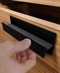 Self Adhesive Edge Finger Pull Door Handle attached to wooden cabinet drawer.