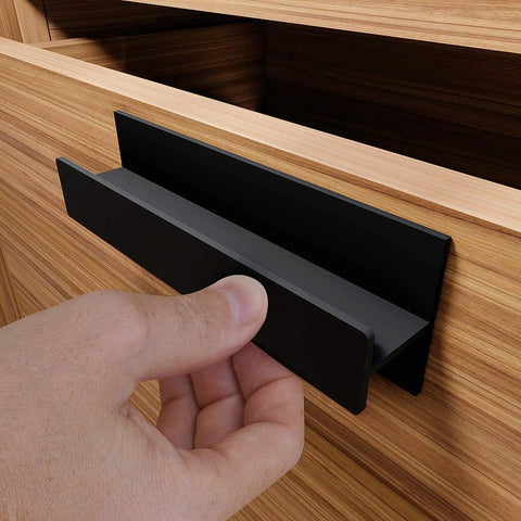 Self Adhesive Edge Finger Pull Door Handle attached to wooden cabinet drawer.