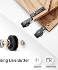 Effortless 5 Ft Bypass Double Sliding Barn Door Hardware Kit With Single Track That Slides Like Butter Quiet Ball Bearing Rollers Easy Install For 35 Inch Wide Double Doors Durable Aluminum Black Powder Coat Finish, showing rollers and track.