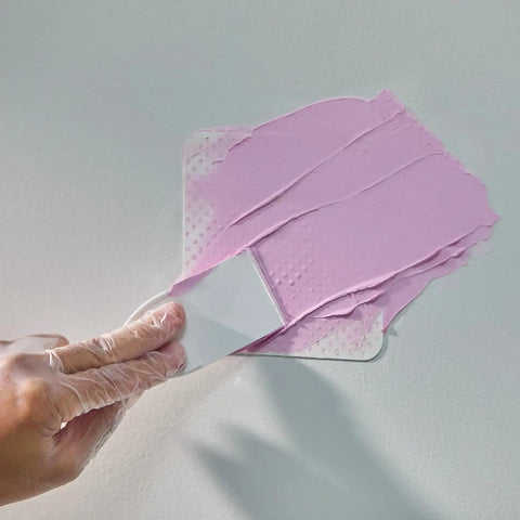 Application of DryDex Spackling Wall Repair Patch Kit With Pink To White Dry Time Indicator 8 Oz on wall surface.