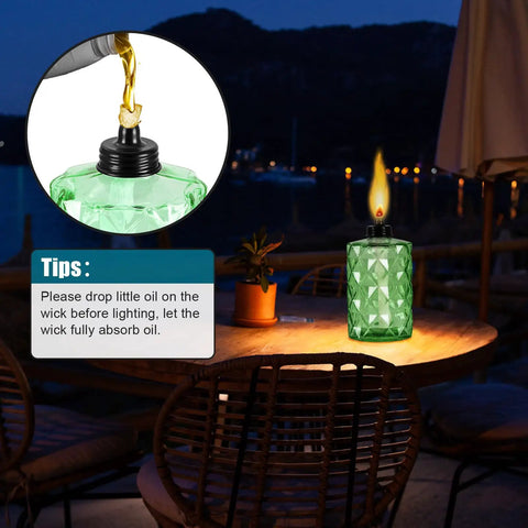 Outdoor Table Top Torch Set With 12 Oz Refill Canisters And Wicks Green Patio Torches For Luau Parties And Garden Decor DIY Backyard Lighting Includes Covers 4 Pack For A Lit Backyard Nighttime Vibe on a wooden table at night