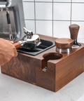 Level Up Your Home Bar Setup With This Sturdy Wood Espresso Tamper Holder And Knock Box For 58mm Portafilters, Keeps Your Workspace Crisp And Totally Stress Free, featuring a hand holding portafilter.