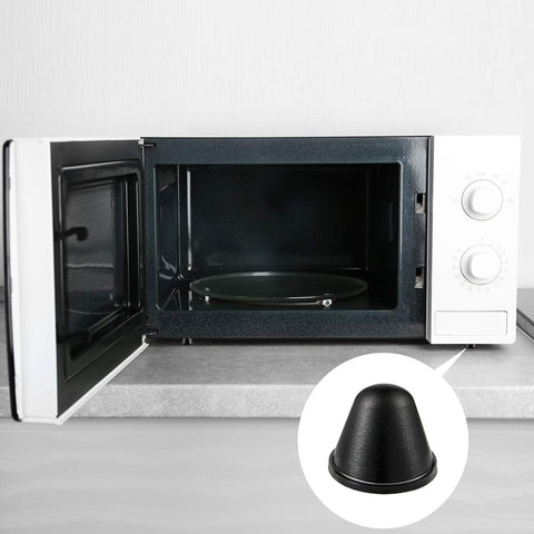 DIY Friendly Self Adhesive Black Conical Rubber Bumpers Set of 24 next to an open microwave on a countertop