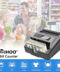 Portable Money Counter With UV And MG Counterfeit Detection in use at grocery checkout, counting dollar bills, black and gray.