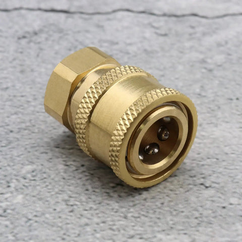Close-up of Set Of 2 Pressure Washer Adapters Quarter Inch Quick Connect To M14 Thread Brass Coupling on gray surface.