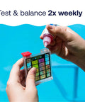 Hand holding Nail Flawless Pool Chemistry In A Snap With This Six Way Swimming Pool Water Test Kit analyzing water quality.
