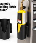 Solid Magnetic Welding Torch Holder That Clamps Securely To Any Metal Surface For Super Easy Bernzomatic MAP-Pro Access And Safe Storage With High Power Industrial Magnets on a metal surface holding a yellow torch cylinder.