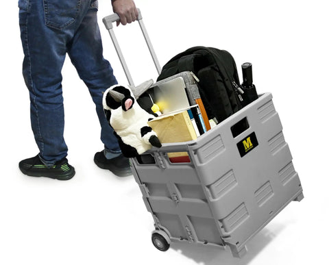 Collapsible Gray Rolling Dolly With Adjustable Handle And Extra Storage For Classroom, Office, And Grocery Runs, Durable Wheels, Easy Fold Design, 250lb Capacity Cart That Makes Moving Messes In A Snap being pulled with items inside
