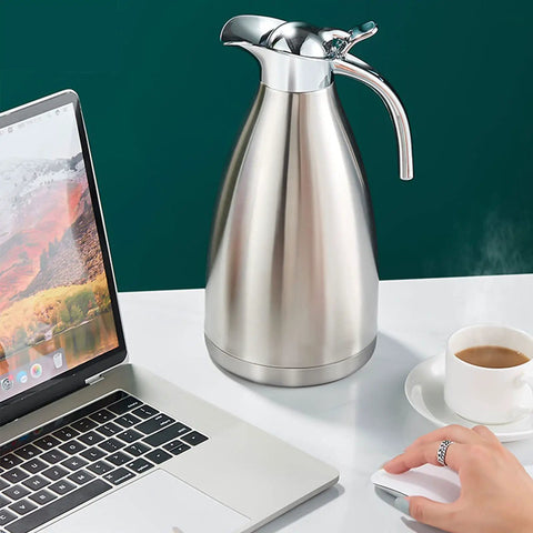 68 Oz Stainless Steel Coffee Thermal Carafe with Double Wall Vacuum Insulation on desk next to laptop and coffee cup