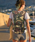 Go To Lightweight Hiking Backpack For Women, Oxford Cloth Daypack In Jungle Camo, worn by a woman outdoors.