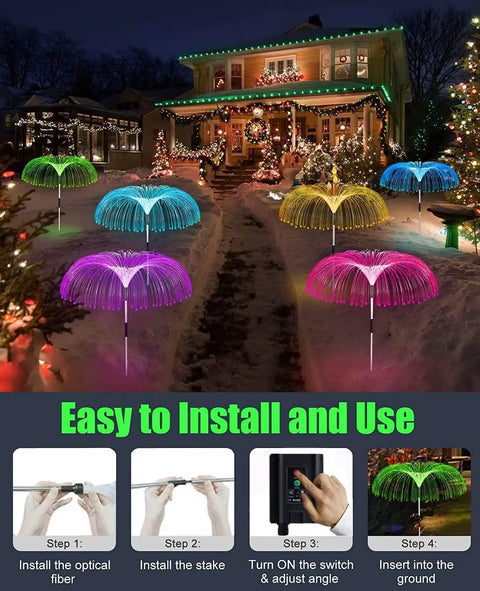 Solar Jellyfish Garden Lights Set Of 5 illuminating a snowy pathway with color-changing LEDs during Christmas at night.
