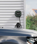 Rugged EV Charger Cable Holster For J1772 Connectors mounted on wall with charging cable neatly organized beside a vehicle.
