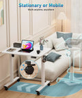 32 Inch Electric Rolling Standing Desk With Adjustable Height, Mobile Sit Stand Desk On Lockable Casters, 31.5 By 23.6 Inch Surface, White Frame And White Top, Space Saving Ergonomic Workstation For Home Office And Computer Setup displayed in living room setup with electronics and decor.