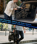 Person placing Powerful Folding Electric Bike With 800W To 1200W Peak Motor For Dope City Commutes 23 MPH in car trunk