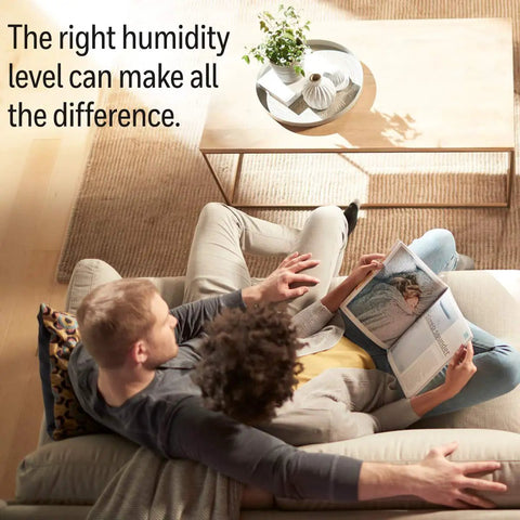 Couple relaxing on a couch reading, highlighting importance of humidity level; context for Replacement Wicking Filter A 3 Pack use.