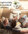 Couple relaxing on couch reading with text 'The right humidity level can make all the difference' visible. Replacement Wicking Filter E For HC14PF3 Evaporative Humidifiers 3 Pack White That Helps Cut Down On Mineral Dust And Keeps Your Water Clean For HCM-6009 HCM-6011 HEV680 HEV685.