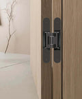 Concealed Hinge For Thick Doors 200 Mm TECTUS TE 540 3D Adjustable on a wood door, rustic umber finish, 180° opening.