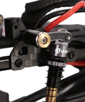 Close-up of CNC Aluminum Shock Flex Blades for SCX24 1 24 RC Crawler Upgrade installed on vehicle frame, showing precision fit.